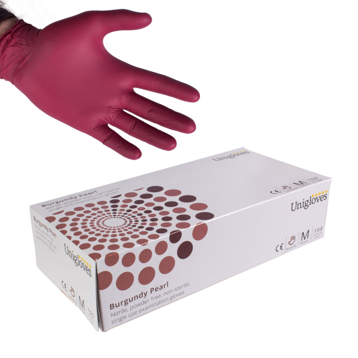 Hand wearing burgundy nitrile glove above box of 100 Uniglove Burgundy Pearl gloves.